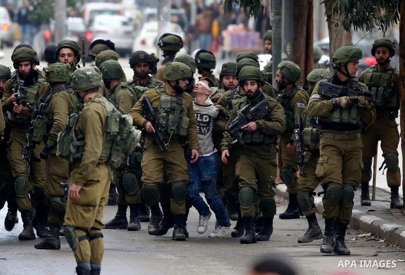 Israeli forces detain a Palestinian protester during clashes that followed protests against a decision by US President Donald Trump to recognise Jerusalem as the capital of Israel, in Hebron in the Israeli-occupied West...