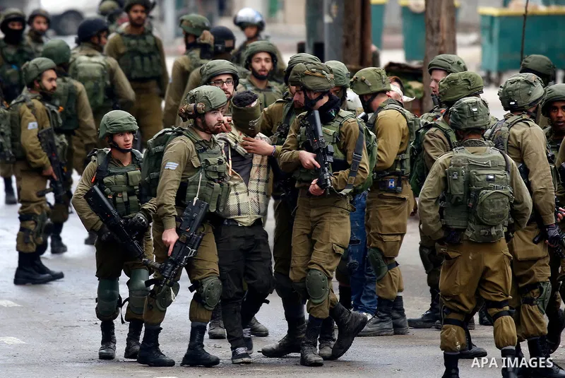 Israeli forces detain a Palestinian protester during clashes that followed protests against a decision by US President Donald Trump to recognise Jerusalem as the capital of Israel, in Hebron in the Israeli-occupied West...
