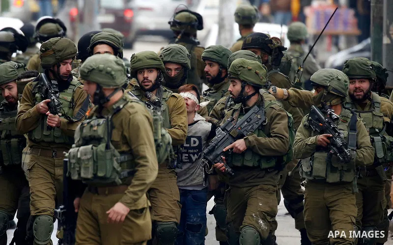 Israeli forces detain a Palestinian protester during clashes that followed protests against a decision by US President Donald Trump to recognise Jerusalem as the capital of Israel, in Hebron in the Israeli-occupied West...