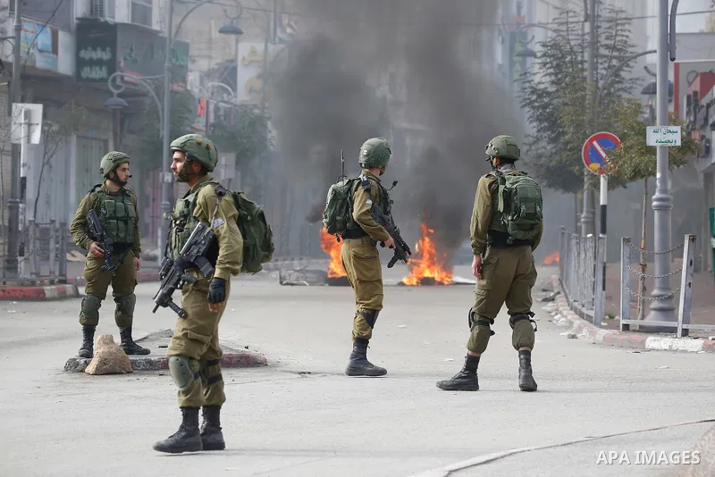Israeli forces detain a Palestinian protester during clashes that followed protests against a decision by US President Donald Trump to recognise Jerusalem as the capital of Israel, in Hebron in the Israeli-occupied West...
