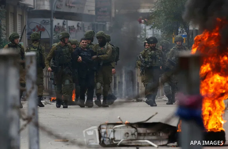 Israeli forces detain a Palestinian protester during clashes that followed protests against a decision by US President Donald Trump to recognise Jerusalem as the capital of Israel, in Hebron in the Israeli-occupied West...