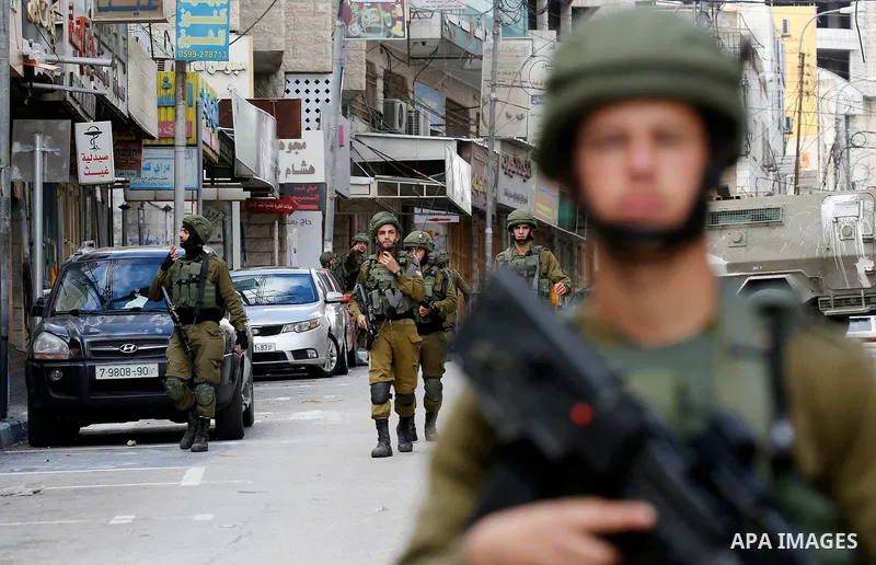 Israeli border policemen take position during clashes that followed protests against a decision by US President Donald Trump to recognise Jerusalem as the capital of Israel, in the West Bank city of hebron on December 7,...