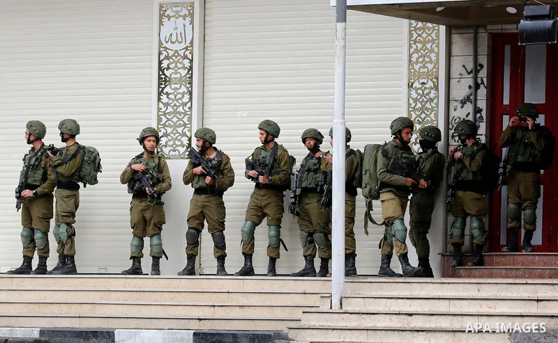 Israeli border policemen take position during clashes that followed protests against a decision by US President Donald Trump to recognise Jerusalem as the capital of Israel, in the West Bank city of hebron on December 7,...