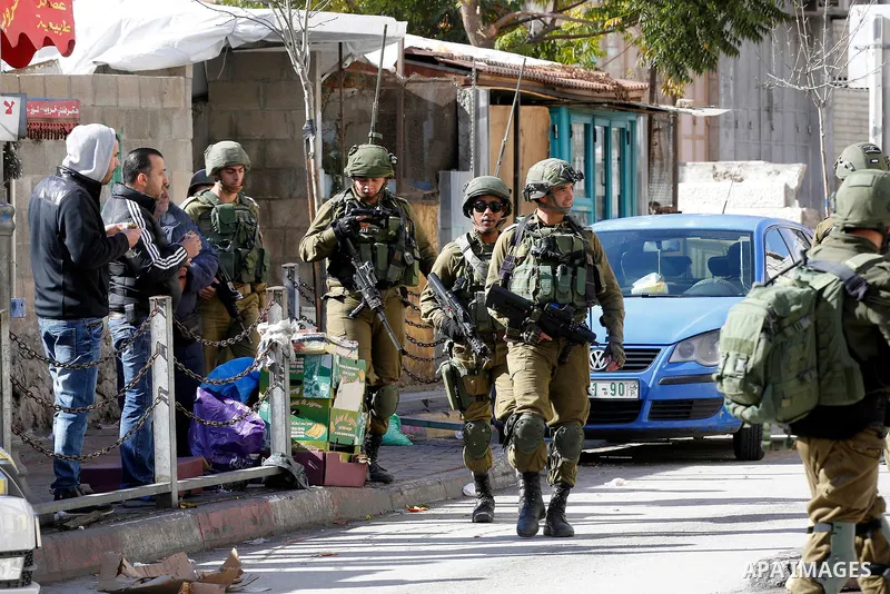 Israeli border policemen take position during clashes that followed protests against a decision by US President Donald Trump to recognise Jerusalem as the capital of Israel, in the West Bank city of hebron on December 7,...