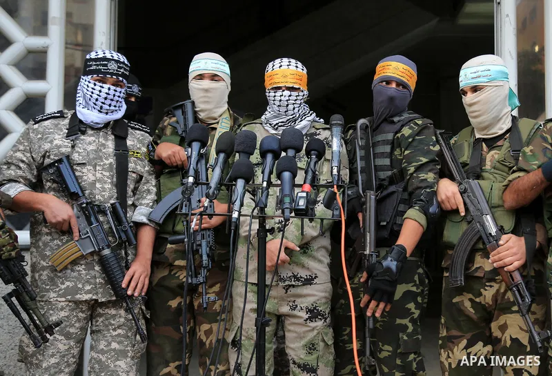 Masked Palestinian militants from Al Aqsa Martyrs' Brigade, a militia linked to the Fatah movement, give a press conference to condemn the decision by U.S. President Trump to recognize Jerusalem as Israel's capital, in G...