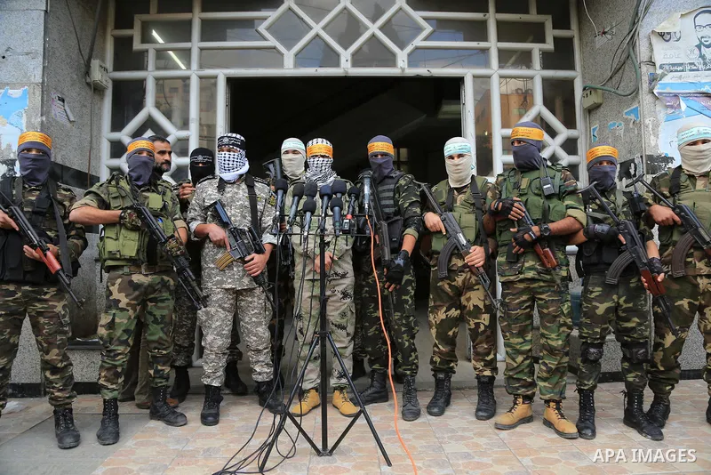 Masked Palestinian militants from Al Aqsa Martyrs' Brigade, a militia linked to the Fatah movement, give a press conference to condemn the decision by U.S. President Trump to recognize Jerusalem as Israel's capital, in G...