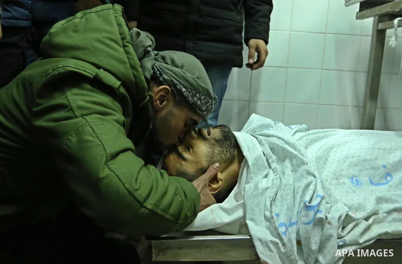 Relatives mourn over the body of 30-year-old Palestinian Mahmoud al-Masri who was shot dead during clashes with Israeli troops, as Palestinians call for a "day of rage" in response to U.S. President Donald Trump's recogn...