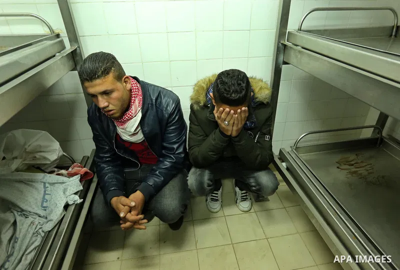 Relatives mourn over the body of 30-year-old Palestinian Mahmoud al-Masri who was shot dead during clashes with Israeli troops, as Palestinians call for a "day of rage" in response to U.S. President Donald Trump's recogn...