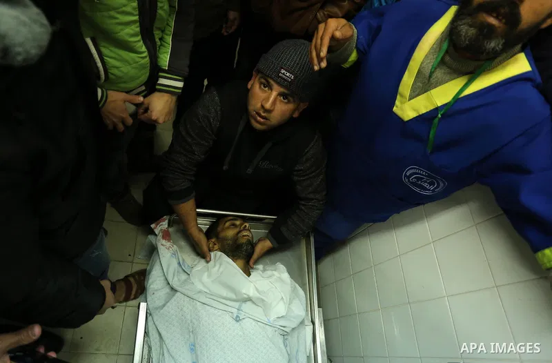 Relatives mourn over the body of 30-year-old Palestinian Mahmoud al-Masri who was shot dead during clashes with Israeli troops, as Palestinians call for a "day of rage" in response to U.S. President Donald Trump's recogn...