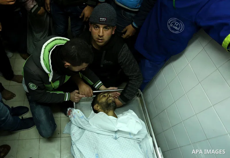 Relatives mourn over the body of 30-year-old Palestinian Mahmoud al-Masri who was shot dead during clashes with Israeli troops, as Palestinians call for a "day of rage" in response to U.S. President Donald Trump's recogn...