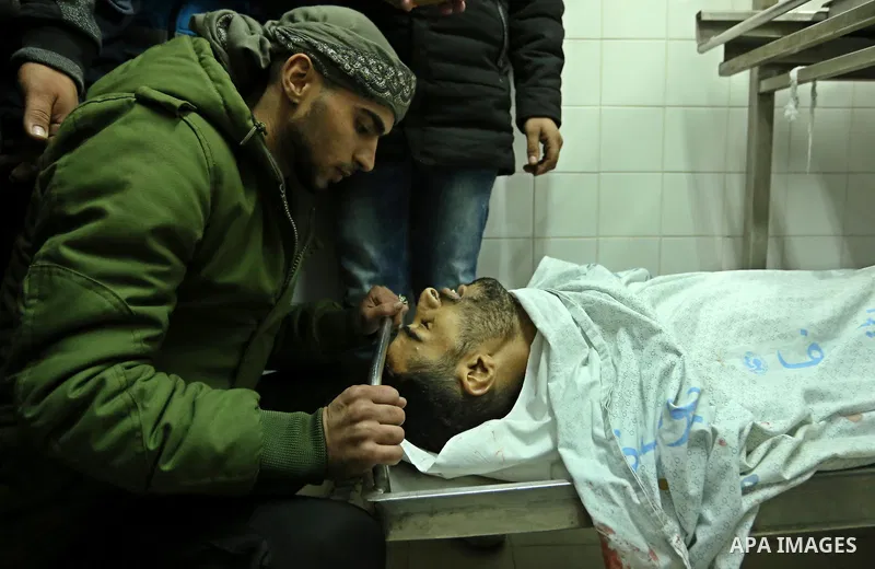 Relatives mourn over the body of 30-year-old Palestinian Mahmoud al-Masri who was shot dead during clashes with Israeli troops, as Palestinians call for a "day of rage" in response to U.S. President Donald Trump's recogn...