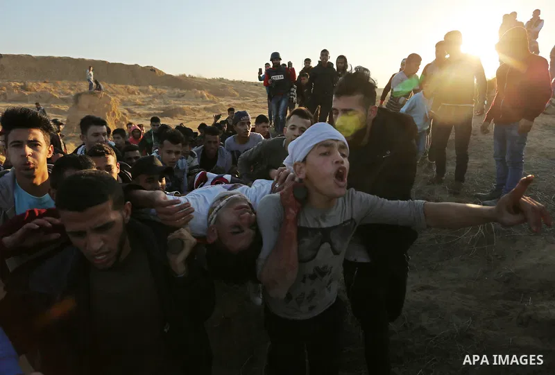 A wounded Palestinian protester is evacuated during clashes with Israeli forces at the Bureij refugee camp, in central Gaza on December 8, 2017. Palestinians clashed with Israeli security forces after calls for a "day of...