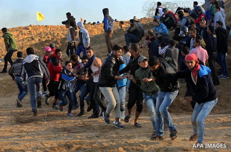 A wounded Palestinian protester is evacuated during clashes with Israeli forces at the Bureij refugee camp, in central Gaza on December 8, 2017. Palestinians clashed with Israeli security forces after calls for a "day of...