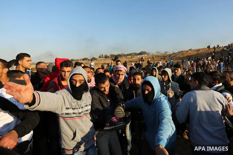 A wounded Palestinian protester is evacuated during clashes with Israeli forces at the Bureij refugee camp, in central Gaza on December 8, 2017. Palestinians clashed with Israeli security forces after calls for a "day of...
