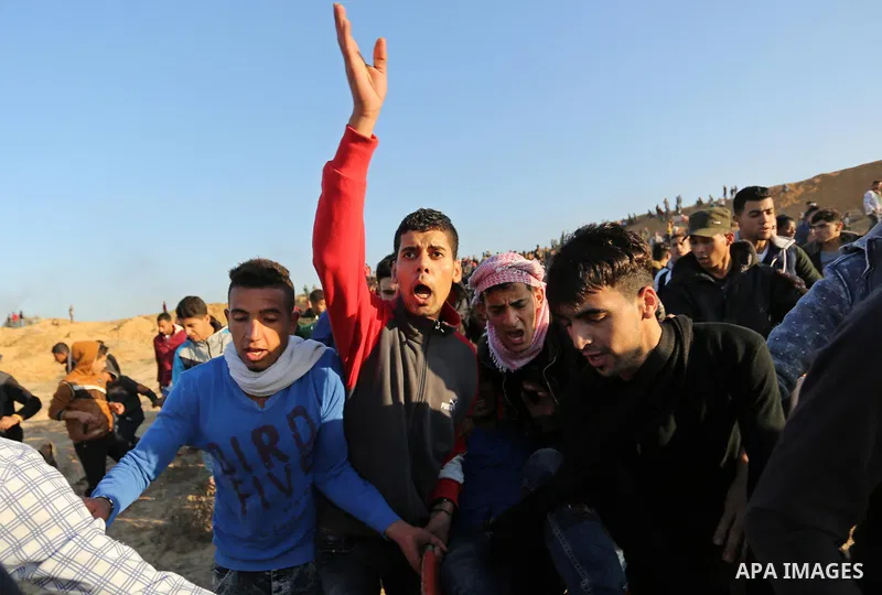 A wounded Palestinian protester is evacuated during clashes with Israeli forces at the Bureij refugee camp, in central Gaza on December 8, 2017. Palestinians clashed with Israeli security forces after calls for a "day of...