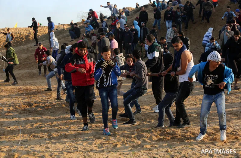 A wounded Palestinian protester is evacuated during clashes with Israeli forces at the Bureij refugee camp, in central Gaza on December 8, 2017. Palestinians clashed with Israeli security forces after calls for a "day of...