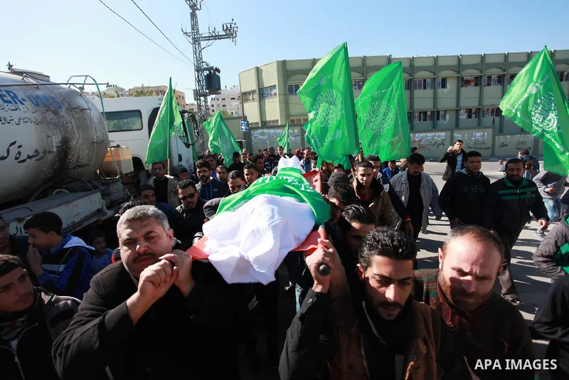 Palestinian mourners carry the body of Maher Atallah a 54-year-old Palestinian man who was killed the previous day in clashes with Israeli troops, during his funeral in Beit Lahia, in the northern Gaza Strip, on December...