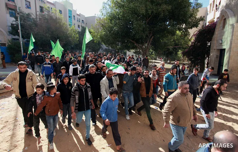 Palestinian mourners carry the body of Maher Atallah a 54-year-old Palestinian man who was killed the previous day in clashes with Israeli troops, during his funeral in Beit Lahia, in the northern Gaza Strip, on December...