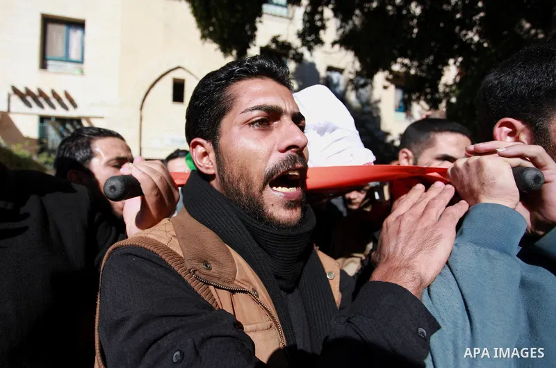 Palestinian mourners carry the body of Maher Atallah a 54-year-old Palestinian man who was killed the previous day in clashes with Israeli troops, during his funeral in Beit Lahia, in the northern Gaza Strip, on December...