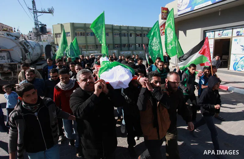 Palestinian mourners carry the body of Maher Atallah a 54-year-old Palestinian man who was killed the previous day in clashes with Israeli troops, during his funeral in Beit Lahia, in the northern Gaza Strip, on December...