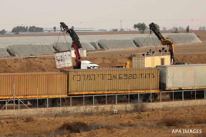 A picture taken on December 10, 2017 shows Israeli heavy machinery seen on the Israeli side of the border with the Gaza strip east of the southern city of Khan Yunis , after a tunnel was discovered in the area. New prote...