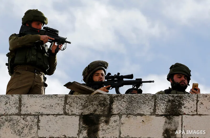 Israeli secrity forces take position during clashes with Palestinian protesters in the city centre of the West Bank town of Hebron on December 11, 2017 as demonstrations continue to flare in the Middle East and elsewhere...