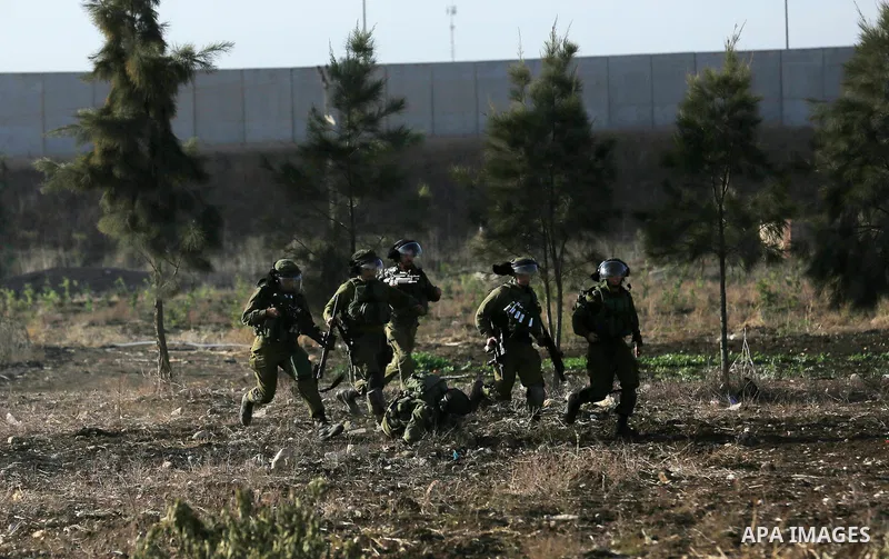 Israeli security forces chase Palestinian protestors during clashes in the West Bank town of Tulkarem, following a demonstration against US President Donald Trump's decision to recognise Jerusalem as the capital of Israe...