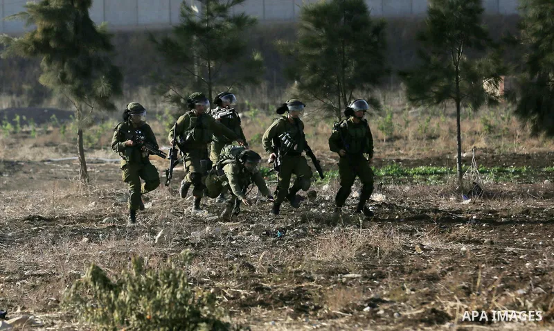 Israeli security forces chase Palestinian protestors during clashes in the West Bank town of Tulkarem, following a demonstration against US President Donald Trump's decision to recognise Jerusalem as the capital of Israe...