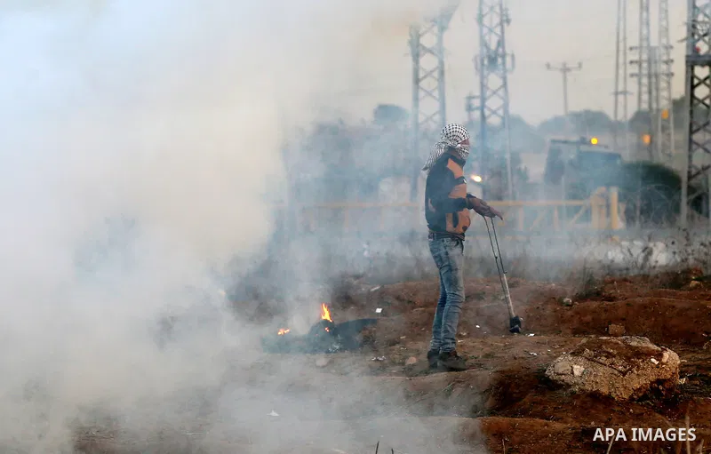 Palestinian protesters clash with Israeli secrity forces near the border fence with Israel, east of Gaza City on December 11, 2017 as demonstrations continue to flare in the Middle East and elsewhere over US President Do...