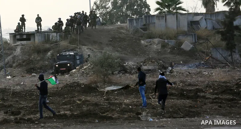 Palestinian protesters hurl stones towards Israeli security forces during clashes in the West Bank town of Tulkarem, following a demonstration against US President Donald Trump's decision to recognise Jerusalem as the ca...