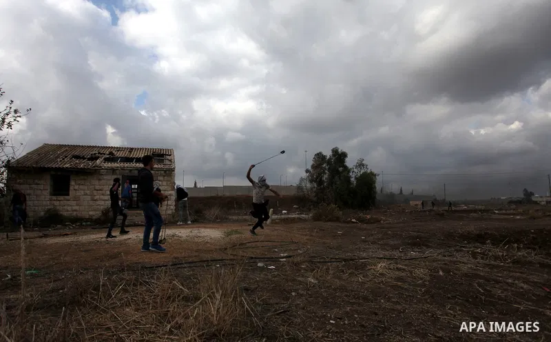 Palestinian protesters hurl stones towards Israeli security forces during clashes in the West Bank town of Tulkarem, following a demonstration against US President Donald Trump's decision to recognise Jerusalem as the ca...