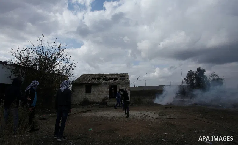 Palestinian protesters hurl stones towards Israeli security forces during clashes in the West Bank town of Tulkarem, following a demonstration against US President Donald Trump's decision to recognise Jerusalem as the ca...