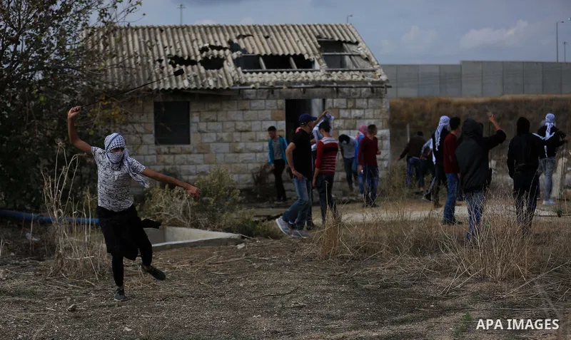 Palestinian protesters hurl stones towards Israeli security forces during clashes in the West Bank town of Tulkarem, following a demonstration against US President Donald Trump's decision to recognise Jerusalem as the ca...
