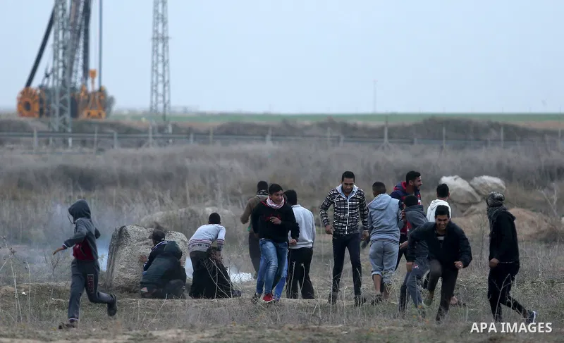 Palestinian protesters clash with Israeli secrity forces near the border fence with Israel, east of Gaza City on December 13, 2017 as demonstrations continue to flare in the Middle East and elsewhere over US President Do...
