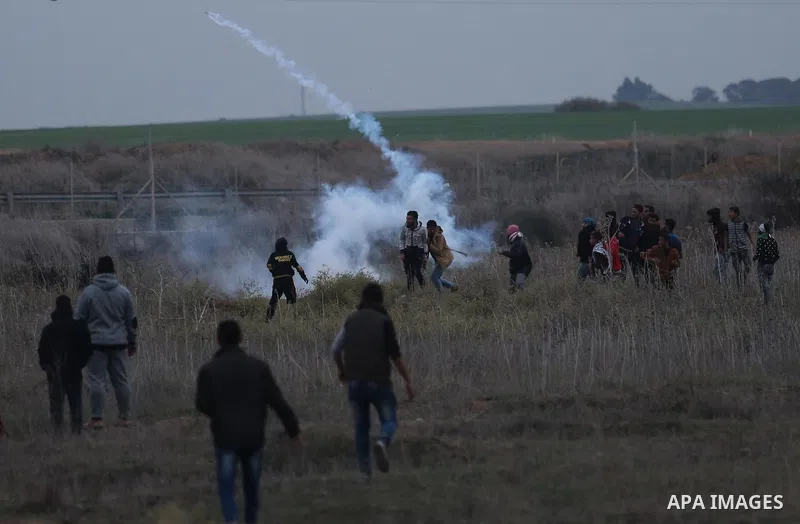 Palestinian protesters clash with Israeli secrity forces near the border fence with Israel, east of Gaza City on December 13, 2017 as demonstrations continue to flare in the Middle East and elsewhere over US President Do...