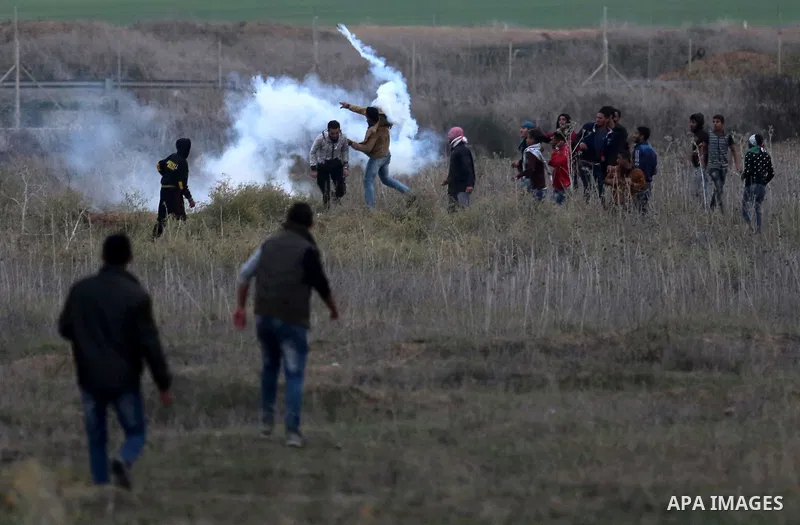 Palestinian protesters clash with Israeli secrity forces near the border fence with Israel, east of Gaza City on December 13, 2017 as demonstrations continue to flare in the Middle East and elsewhere over US President Do...