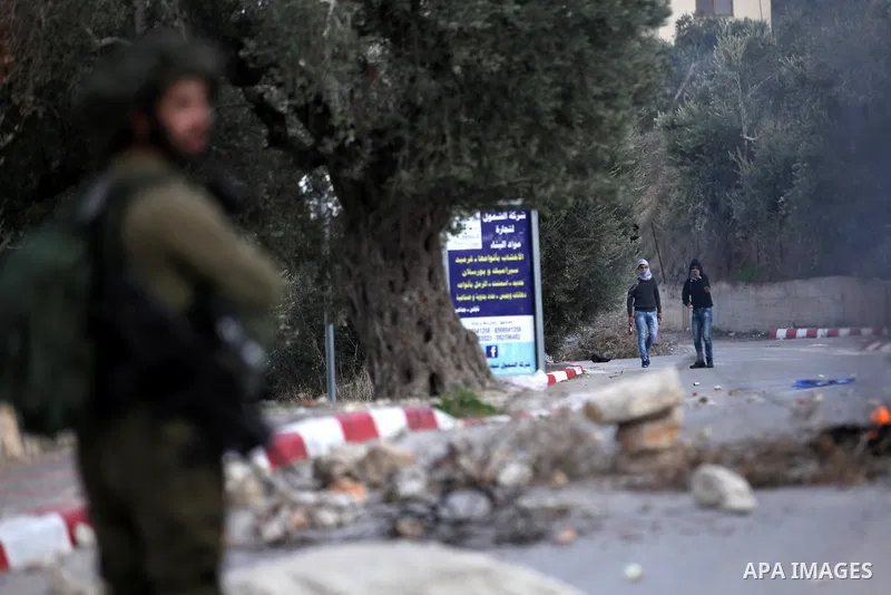 Palestinian protestors, from the nearby Palestinian village of Naqura, confront Israeli security forces close to the Jewish settlement of Shavei Shomron near the West Bank city of Tulkarem on December 14, 2017, as protes...