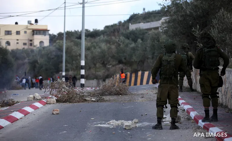 Palestinian protestors, from the nearby Palestinian village of Naqura, confront Israeli security forces close to the Jewish settlement of Shavei Shomron near the West Bank city of Tulkarem on December 14, 2017, as protes...
