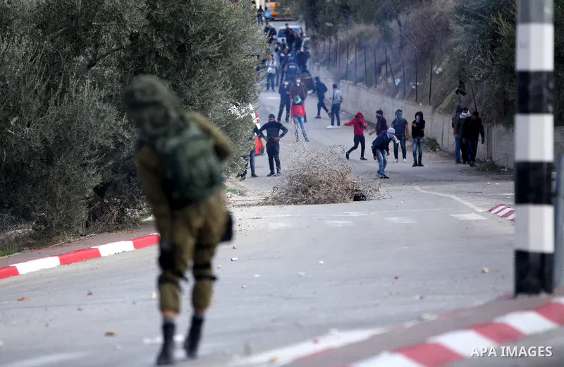Palestinian protestors, from the nearby Palestinian village of Naqura, confront Israeli security forces close to the Jewish settlement of Shavei Shomron near the West Bank city of Tulkarem on December 14, 2017, as protes...