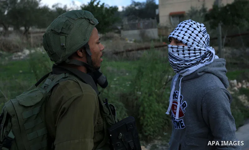 Palestinian protestors, from the nearby Palestinian village of Naqura, confront Israeli security forces close to the Jewish settlement of Shavei Shomron near the West Bank city of Tulkarem on December 14, 2017, as protes...