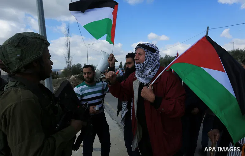 Palestinian protestors, from the nearby Palestinian village of Naqura, confront Israeli security forces close to the Jewish settlement of Shavei Shomron near the West Bank city of Tulkarem on December 14, 2017, as protes...
