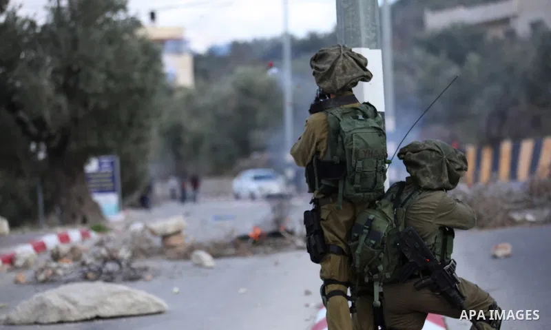 Palestinian protestors, from the nearby Palestinian village of Naqura, confront Israeli security forces close to the Jewish settlement of Shavei Shomron near the West Bank city of Tulkarem on December 14, 2017, as protes...