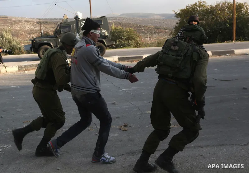 Israeli security forces arrest aPalestinian protester during clashes near the Huwara checkpoint, south of Nablus in the Israeli-occupied West Bank, on December 15, 2017, as protests continue in the region amid anger over...