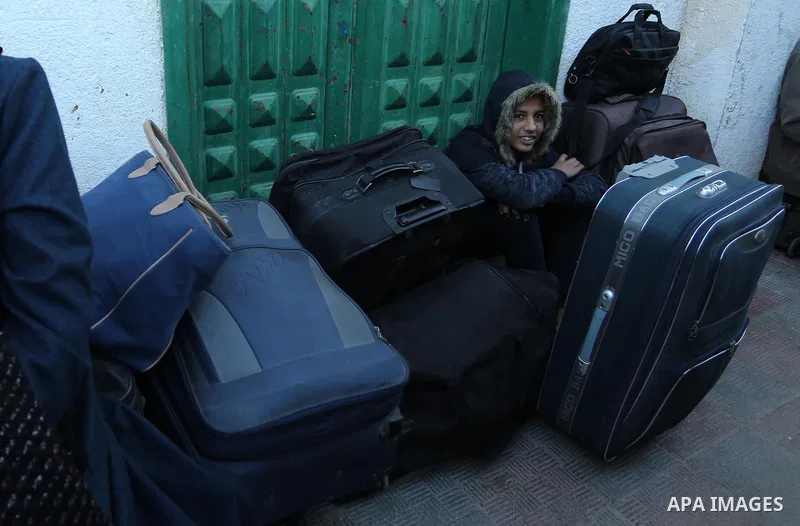 Palestinians wait for travel permits to cross into Egypt through the Rafah border crossing, in Khan Younis in the southern Gaza Strip December 16, 2017. The Palestinian crossing and borders Authority in the Gaza Strip an...