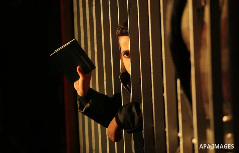 Palestinians wait for travel permits to cross into Egypt through the Rafah border crossing, in Khan Younis in the southern Gaza Strip December 16, 2017. The Palestinian crossing and borders Authority in the Gaza Strip an...