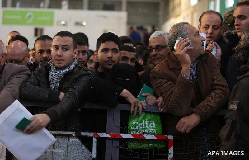 Palestinians wait for travel permits to cross into Egypt through the Rafah border crossing, in Khan Younis in the southern Gaza Strip December 16, 2017. The Palestinian crossing and borders Authority in the Gaza Strip an...