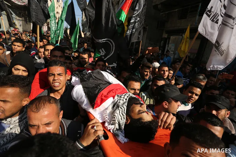 Palestinians carry the body of 29-year-old Ibrahim Abu Thurayeh during his funeral in Gaza City on December 16, 2017 after he was shot dead in clashes between Israeli forces and protesters along the Gaza-Israel border, a...