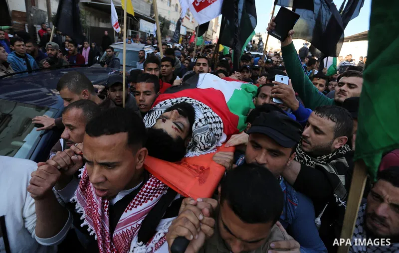 Palestinians carry the body of 29-year-old Ibrahim Abu Thurayeh during his funeral in Gaza City on December 16, 2017 after he was shot dead in clashes between Israeli forces and protesters along the Gaza-Israel border, a...