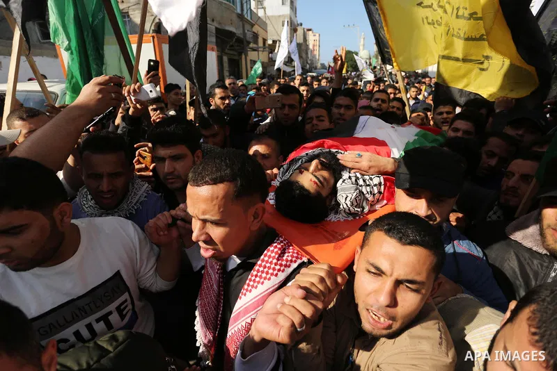 Palestinians carry the body of 29-year-old Ibrahim Abu Thurayeh during his funeral in Gaza City on December 16, 2017 after he was shot dead in clashes between Israeli forces and protesters along the Gaza-Israel border, a...