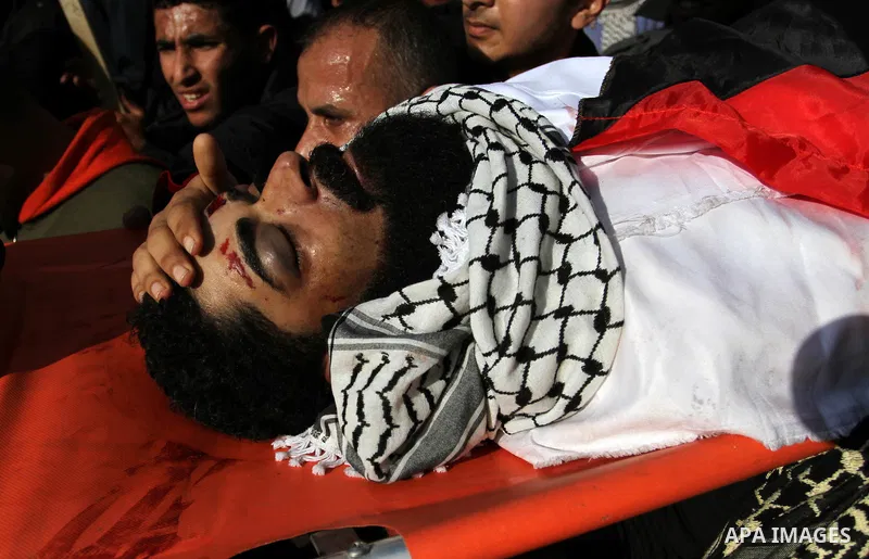 Palestinians carry the body of 29-year-old Ibrahim Abu Thurayeh during his funeral in Gaza City on December 16, 2017 after he was shot dead in clashes between Israeli forces and protesters along the Gaza-Israel border, a...